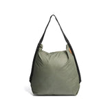 Sage Peak Design packable tote bag with adjustable straps and spacious interior, shown folded and expanded for versatile carrying.