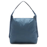Peak Design packable tote bag in ocean blue, showing its lightweight, foldable design and spacious interior for versatile use.
