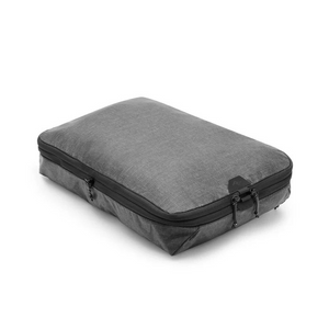 Large Peak Design packing cube with multiple compartments for organized travel storage.