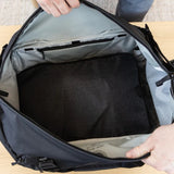 Large Peak Design packing cube with multiple compartments and zipper closure, shown in a neutral color for organized travel storage.