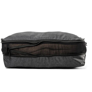 Large Peak Design packing cubes, shown in mesh with zipper closures, designed for organized travel storage.