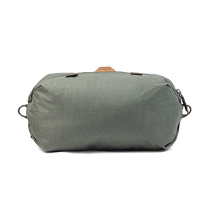 Peak Design Shoe Pouch in sage color, compact travel accessory with zippered compartments for organizing shoes and small items.