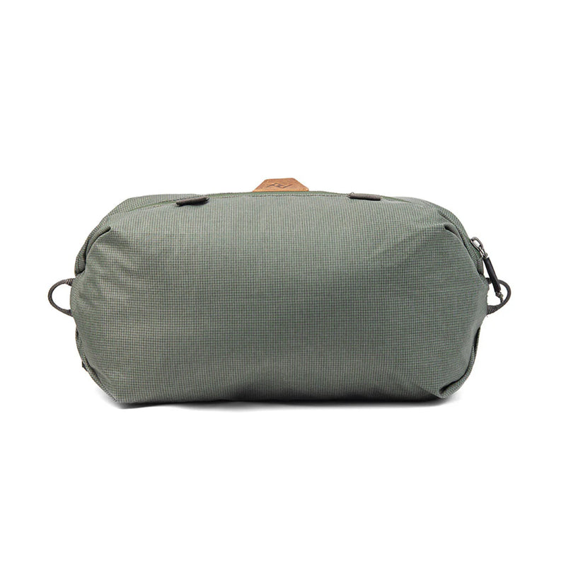 Peak Design Shoe Pouch in sage color, compact travel organizer with zipper closure and durable material for footwear storage.