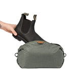 Peak Design Shoe Pouch in sage green, compact travel accessory with zip closure and mesh ventilation for organizing shoes.