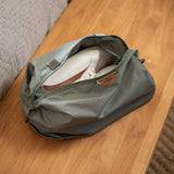 Peak Design Shoe Pouch in sage green, compact travel organizer with multiple compartments for shoes and accessories.
