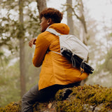 Peak Design Outdoor Sling 7L in cloud color, compact sling bag with adjustable strap and multiple compartments for outdoor gear.