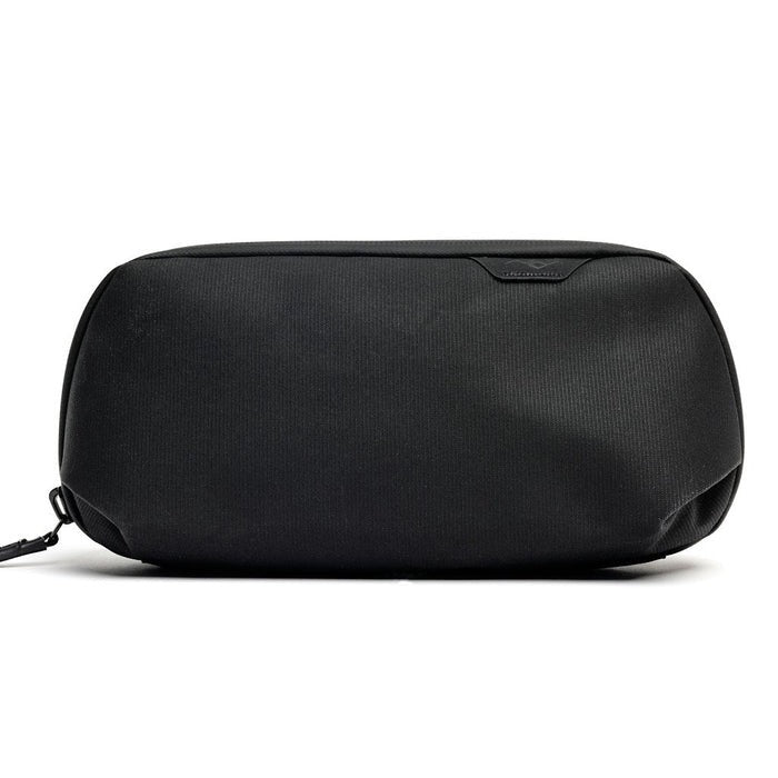 Small Sage Peak Design Tech Pouch used as a tech kit, with compartments for cables, chargers, and accessories.
