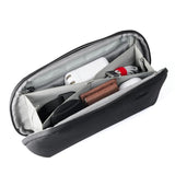 Small Peak Design Tech Pouch in sage, showing organized interior with compartments for tech accessories and cables.