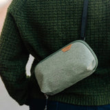 Small Peak Design Tech Pouch in sage color, featuring multiple compartments for organizing tech accessories and cables.