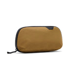 Small sage Peak Design Tech Pouch with multiple compartments for organizing tech accessories and cables.
