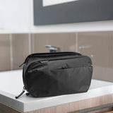 Peak Design Wash Pouch toiletry bag in coyote color with X-PAC material, compact and durable for travel storage.