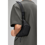 Black Rains Micro Bum Bag by Rains, compact waterproof waist bag with sleek design and adjustable strap.