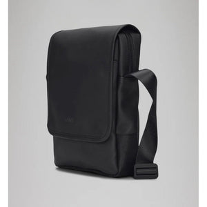 Black RAINS Trail Reporter Bag featuring adjustable straps, multiple pockets, and waterproof material for outdoor use.
