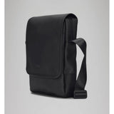 Black RAINS Trail Reporter Bag featuring adjustable straps, multiple pockets, and waterproof material for outdoor use.