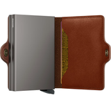 Secrid Twinwallet with saddle-colored leather exterior and compact design, showing card slots and secure cash compartment.