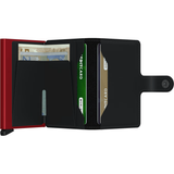 Secrid Miniwallet in matte black and red, open to show card slots and compact design for secure everyday carry.