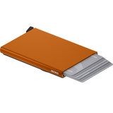 Secrid Cardprotector for MagSafe with vibrant orange finish, compact design holding credit cards and IDs.
