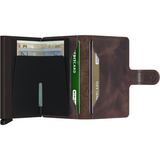 Open Secrid Vintage Miniwallet in chocolate leather showing card slots and compact design.