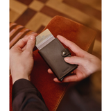 Secrid Miniwallet Original in black and brown with card slots and compact design, shown from a side angle.