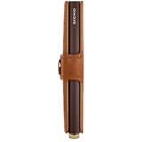 Secrid Premium Miniwallet Emboss in Cognac leather showing embossed logo and side view of compact wallet design.