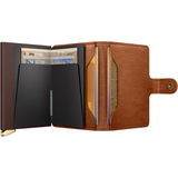 Secrid Premium Miniwallet Emboss in Cognac open with card slots and embossed leather surface, compact and stylish wallet design.