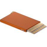 Secrid Premium Cardprotector+ Fluted wallet open showing orange exterior and card slots for secure card storage.