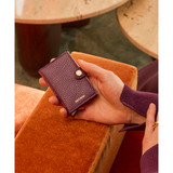 Secrid Miniwallet Pebble in grape color, compact leather wallet with card slots and metal casing for RFID protection.