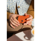Secrid Miniwallet Crisple in vibrant pink leather, showcasing compact design and card slots, on a wooden surface.