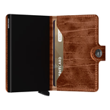 Secrid Miniwallet Dutch-Martin in whiskey leather, compact wallet with card slots and sleek design, shown open with cards inside.