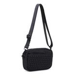 Black Sol & Selene woven neoprene crossbody bag with adjustable strap and modern design.