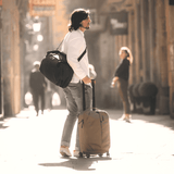 Thule Aion carry-on spinner luggage with four wheels, durable black exterior, and telescopic handle for easy travel.