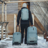 Thule Chasm wheeled carry-on duffel bag with durable fabric, adjustable handle, and side zipper pockets for travel convenience.