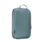 White Thule Compression Cube Set used as packing organizers for efficient travel storage and organization.