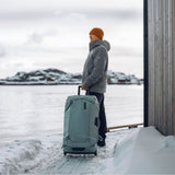 Thule Chasm wheeled checked duffel bag with sturdy handles and wheels, designed for durable travel storage.