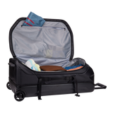 Thule Chasm wheeled checked duffel bag with sturdy handle and large wheels, designed for travel and heavy packing.