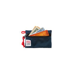 Open navy accessory bag by Topo Designs showing organized compartments for small items and essentials.