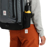 Topo Designs Global Travel Bag 30L backpack in brick coral with detailed straps and compartments, designed for versatile travel use.