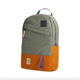 Topo Designs Daypack Classic backpack with durable fabric, adjustable straps, and multiple compartments, shown in a natural outdoor setting.