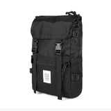Topo Designs Rover Pack Classic backpack with multiple compartments and durable fabric, shown in a natural outdoor setting.