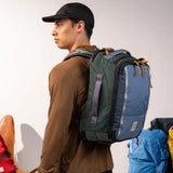 Topo Designs Global Travel Backpack shown with multiple compartments, durable fabric, and adjustable straps for versatile travel use.