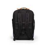 Topo Designs Global Travel Backpack in black with multiple compartments, padded shoulder straps, and durable fabric for outdoor adventures.