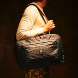 Topo Designs Global Pro 3-Way Briefcase in durable fabric, showing multiple carrying options and spacious interior compartments.