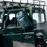 Topo Designs Global Pro Backpack shown in black with multiple compartments and adjustable straps, ideal for travel and daily use.