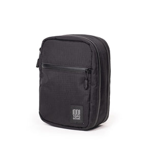 Large image of the Topo Designs Global Pro Tech Case, featuring durable black fabric with secure zipper closure and compact design.