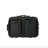 Topo Designs Global Briefcase made of durable fabric with leather accents, featuring a handle and adjustable shoulder strap.