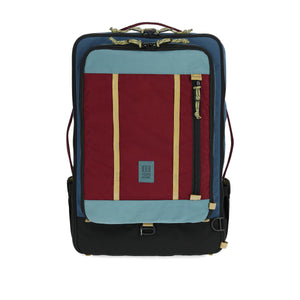 Topo Designs Global Travel Bag 40L carry-on luggage in dark denim and burgundy, front view showing durable fabric and zipper.