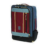 Topo Designs Global Travel Bag 40L carry-on luggage in dark denim and burgundy with multiple compartments and durable fabric.