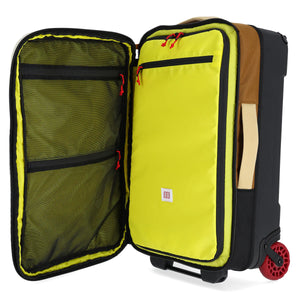 Topo Designs Global Travel Bag Roller carry-on luggage in Bone White and Olive with handles and wheels for easy travel.