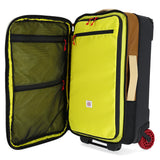 Topo Designs Global Travel Bag Roller carry-on luggage in Bone White and Olive with handles and wheels for easy travel.