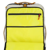 Topo Designs Global Travel Bag Roller carry-on luggage in bone white and olive with wheels and a sturdy handle.